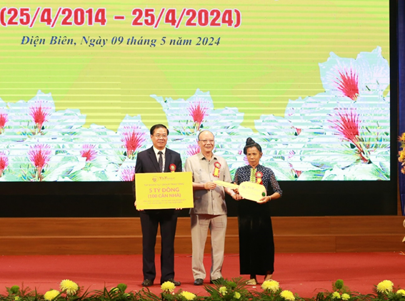 : Ông Nguyễn Tất Thắng, Chủ tịch HĐQT Tập đoàn T&T Group (giữa) trao tặng tỉnh Điện Biên 5 tỷ đồng (100 căn nhà) và trao chìa khoá tượng trưng cho gia đình được hỗ trợ làm nhà.
